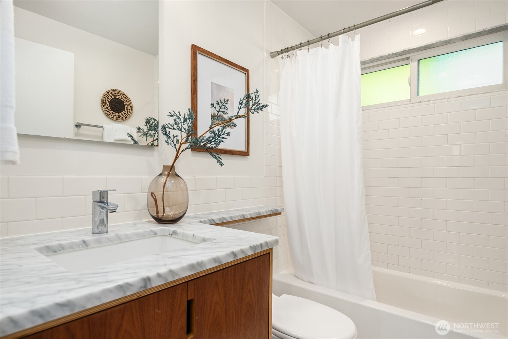 4714 50th Avenue Southwest Seattle, WA 98116 - Photo 19 of 34 a bathroom with a granite countertop sink and a mirror