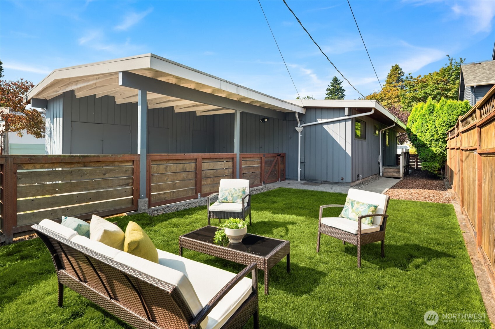4714 50th Avenue Southwest Seattle, WA 98116 - Photo 23 of 34 a backyard of a house with table and chairs