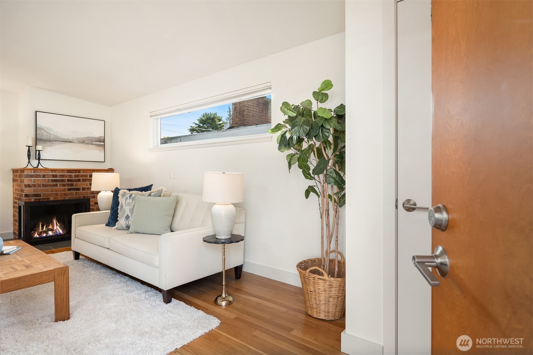 4714 50th Avenue Southwest Seattle, WA 98116 - Photo 4 of 34 a living room with furniture a potted plant and a fireplace