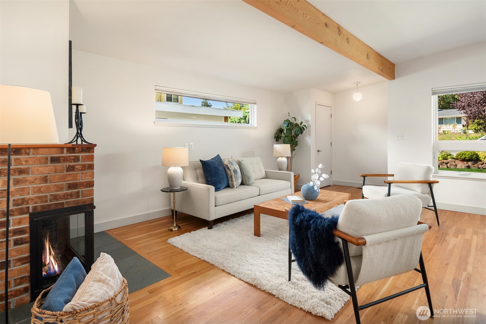4714 50th Avenue Southwest Seattle, WA 98116 - Photo 9 of 34 a living room with furniture a fireplace and a flat screen tv