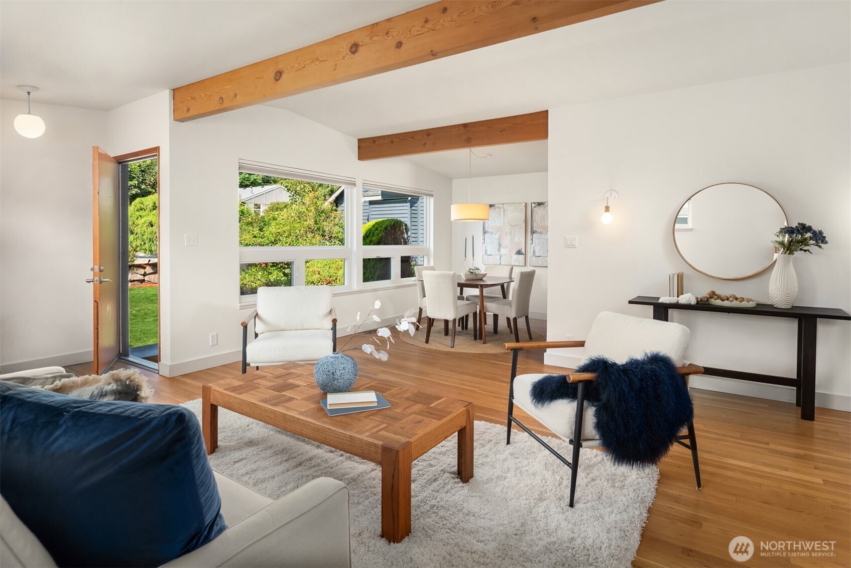 4714 50th Avenue Southwest Seattle, WA 98116 - Photo 10 of 34 a living room with furniture a window and a dining table