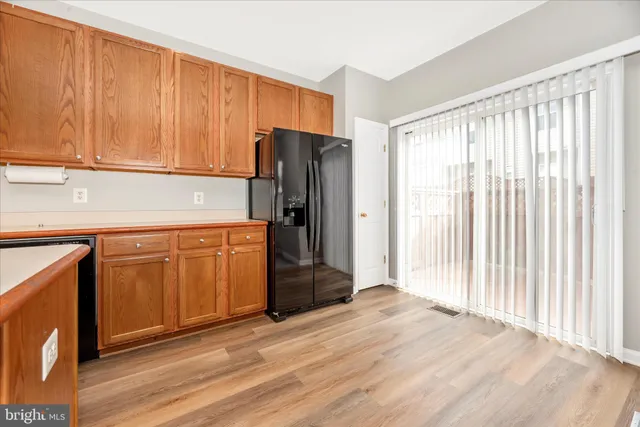 a kitchen with stainless steel appliances granite countertop a sink dishwasher stove and cabinets with wooden floor
