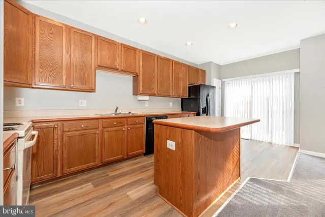 a kitchen with granite countertop cabinets stainless steel appliances and sink
