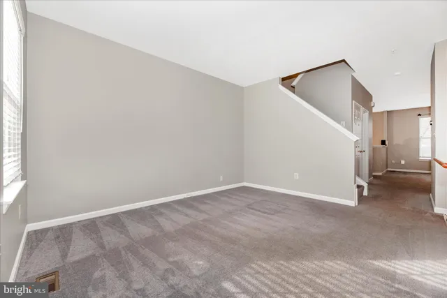 a spacious bedroom with a bed and a window