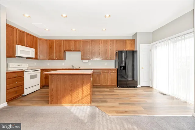 a view of a kitchen with wooden floor