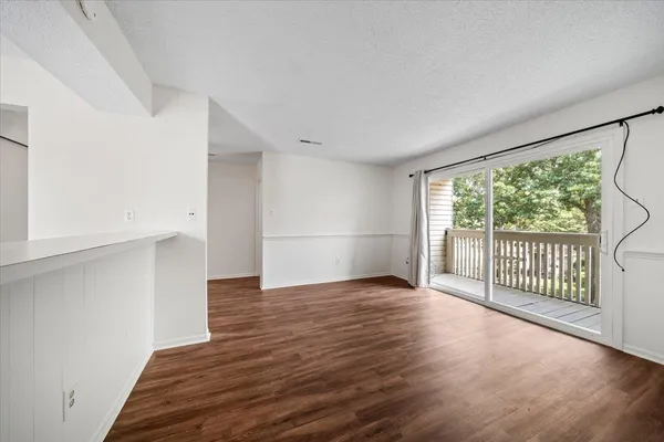 a view of a porch with wooden floor and fence