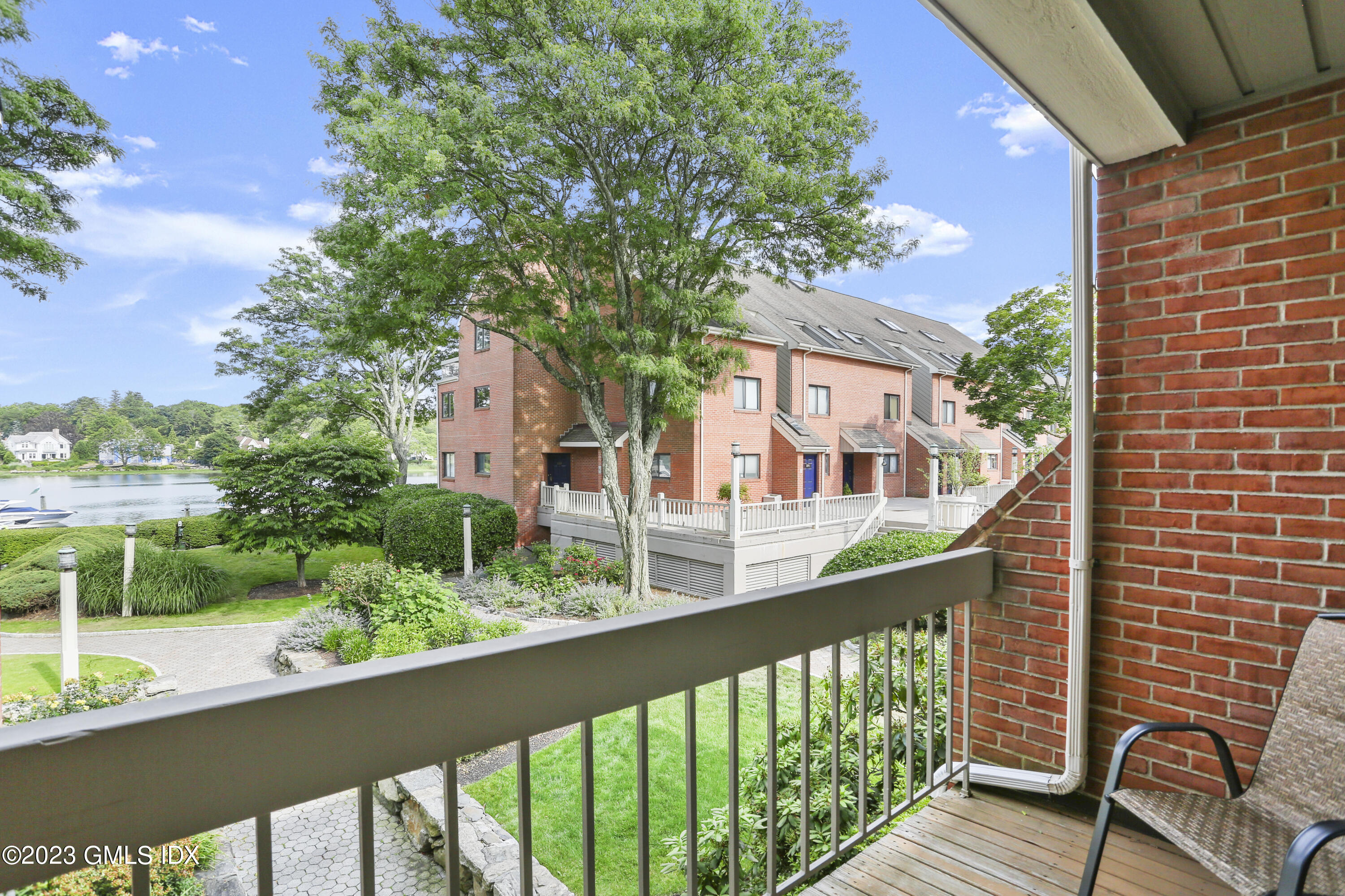 7 River Road, Unit 304 Cos Cob, CT 06807 - Photo 16 of 29 a view of a brick house with a porch