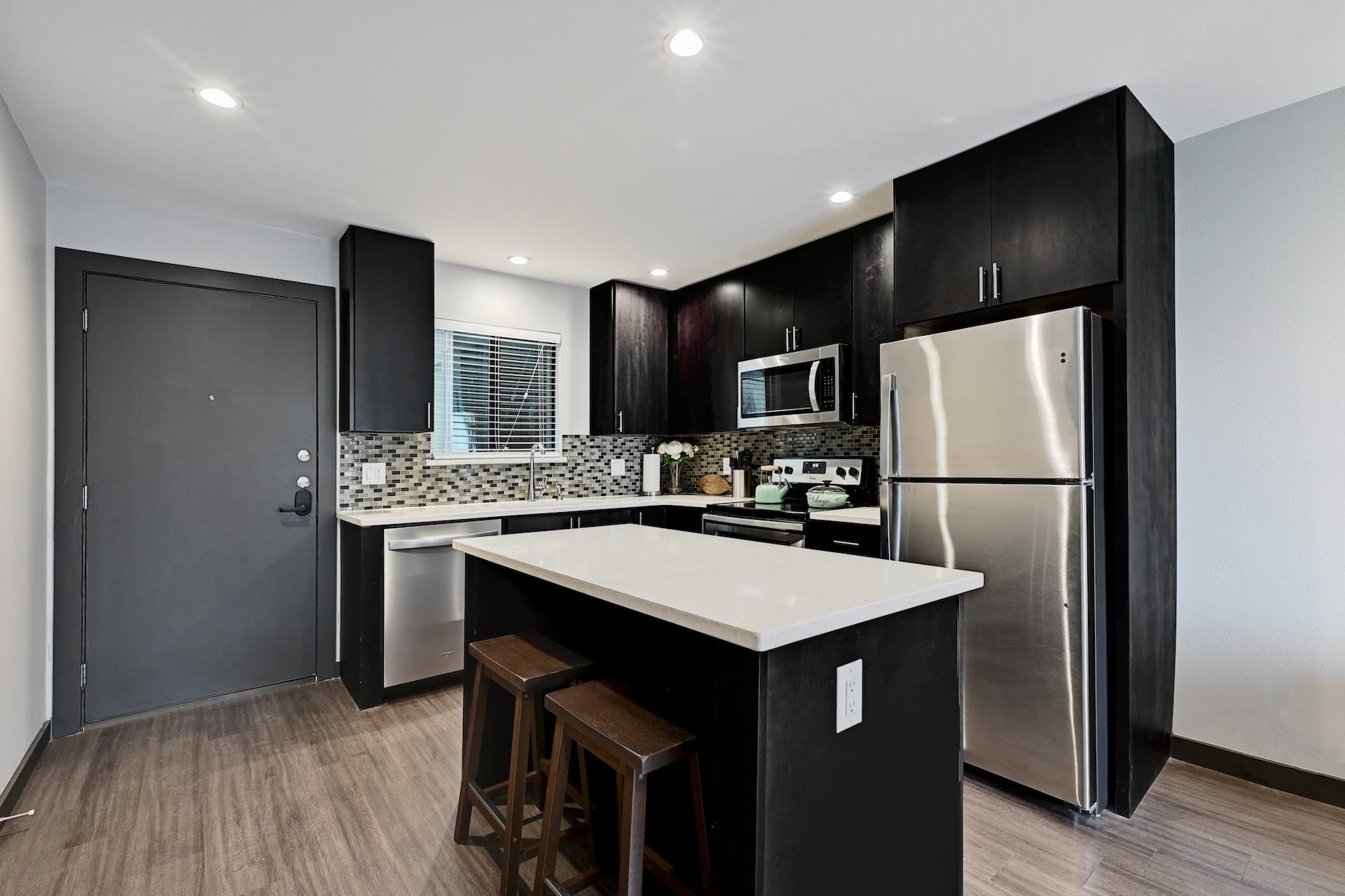 3301 Red River Street, Unit 303 Austin, TX 78705 - Photo 16 of 26 a kitchen with stainless steel appliances a refrigerator and a sink