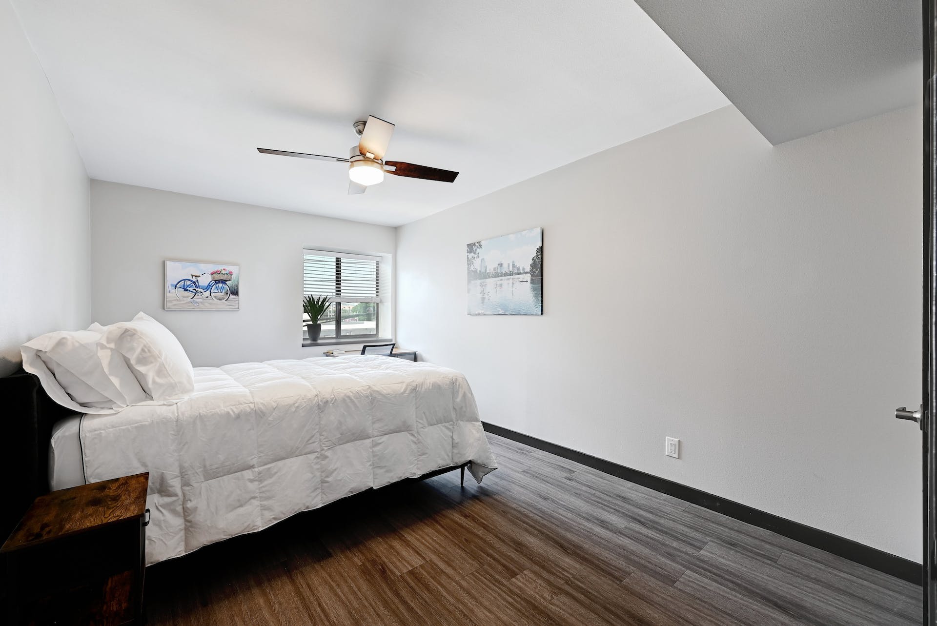 3301 Red River Street, Unit 303 Austin, TX 78705 - Photo 2 of 26 a bedroom with a bed and wooden floor