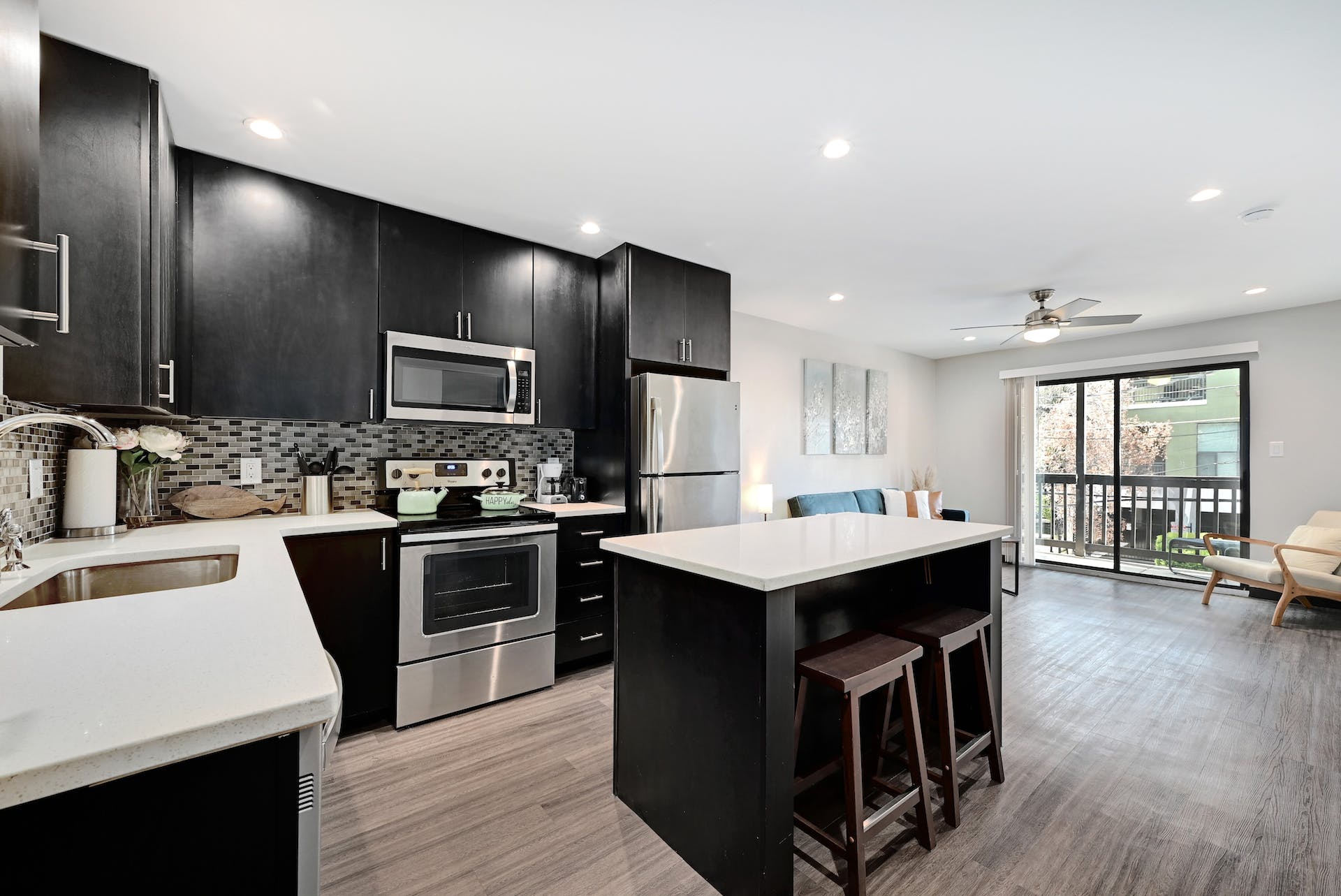 3301 Red River Street, Unit 303 Austin, TX 78705 - Photo 5 of 26 a kitchen with kitchen island a sink counter top space stainless steel appliances and a center island