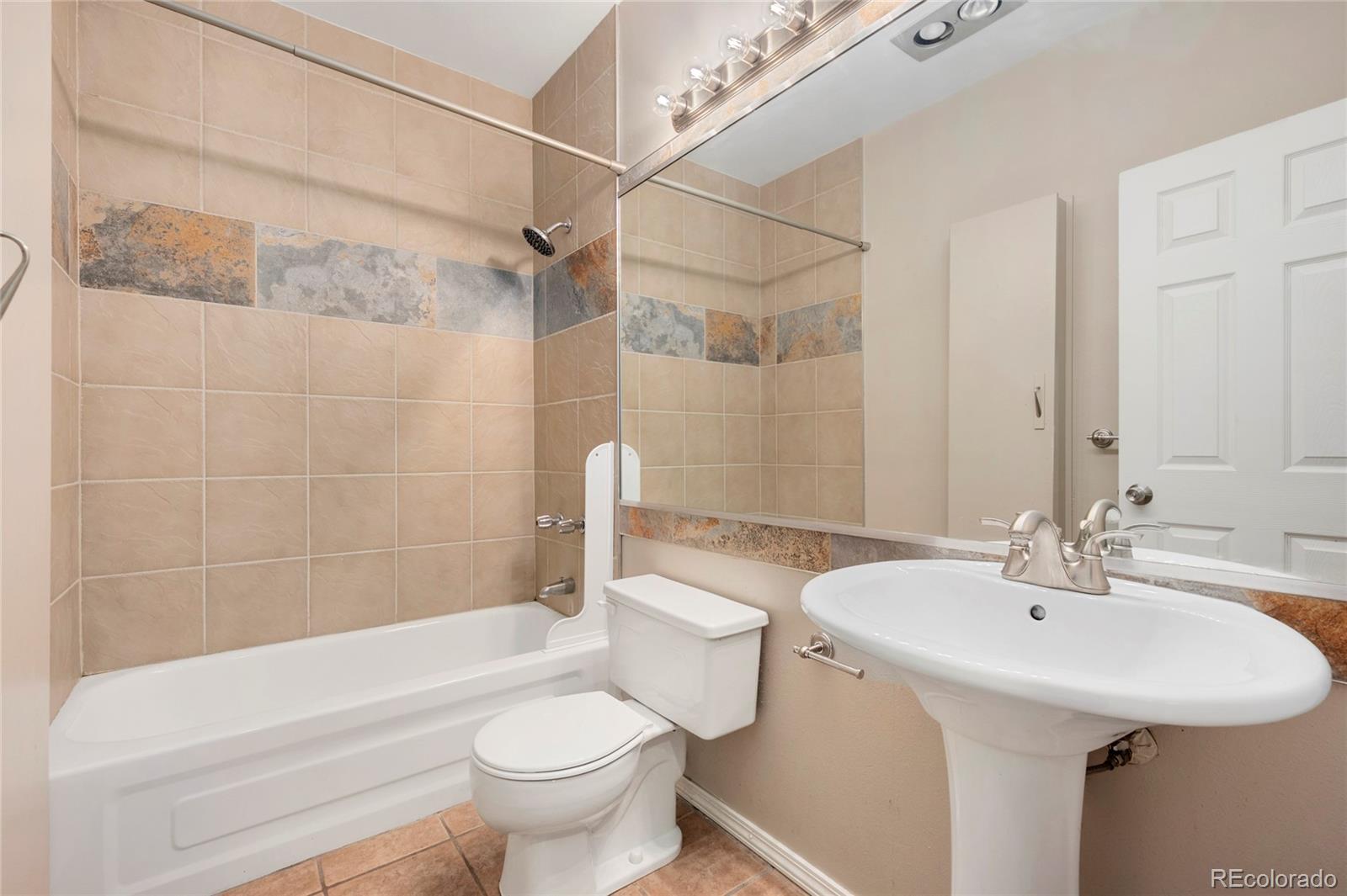 1512 Larimer Street, Unit 21 Denver, CO 80202 - Photo 15 of 18 a bathroom with a sink a toilet and a bathtub