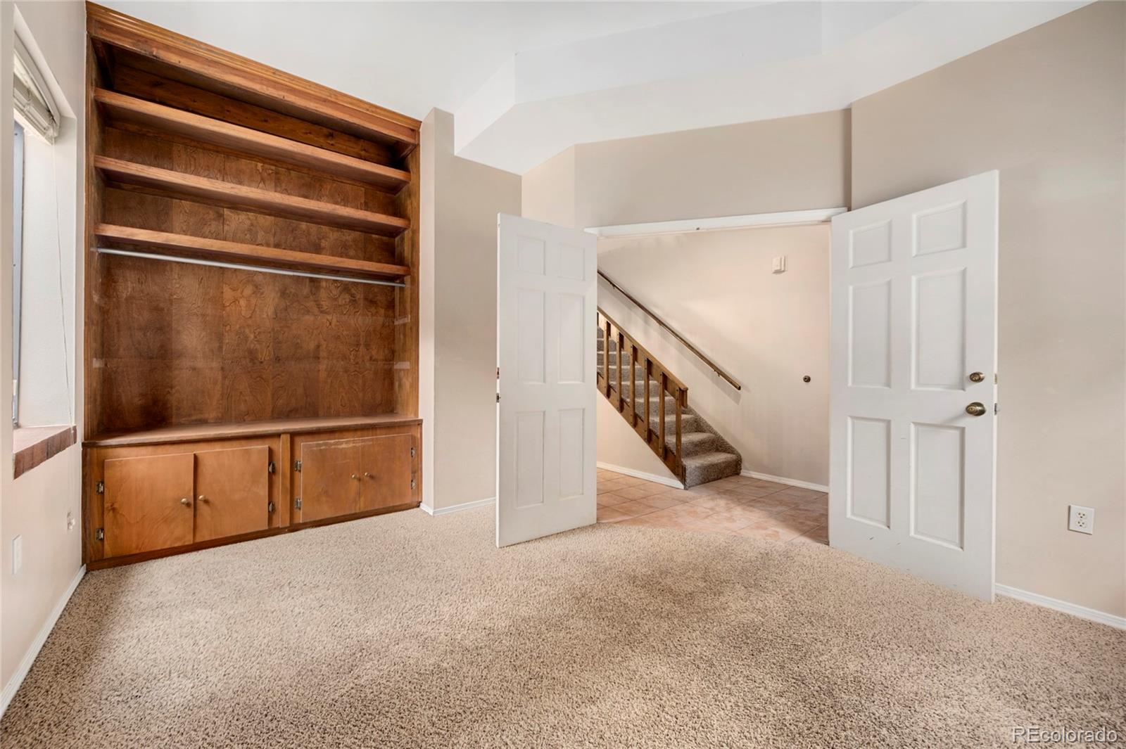 1512 Larimer Street, Unit 21 Denver, CO 80202 - Photo 16 of 18 a view of an empty room with stairs and a living room