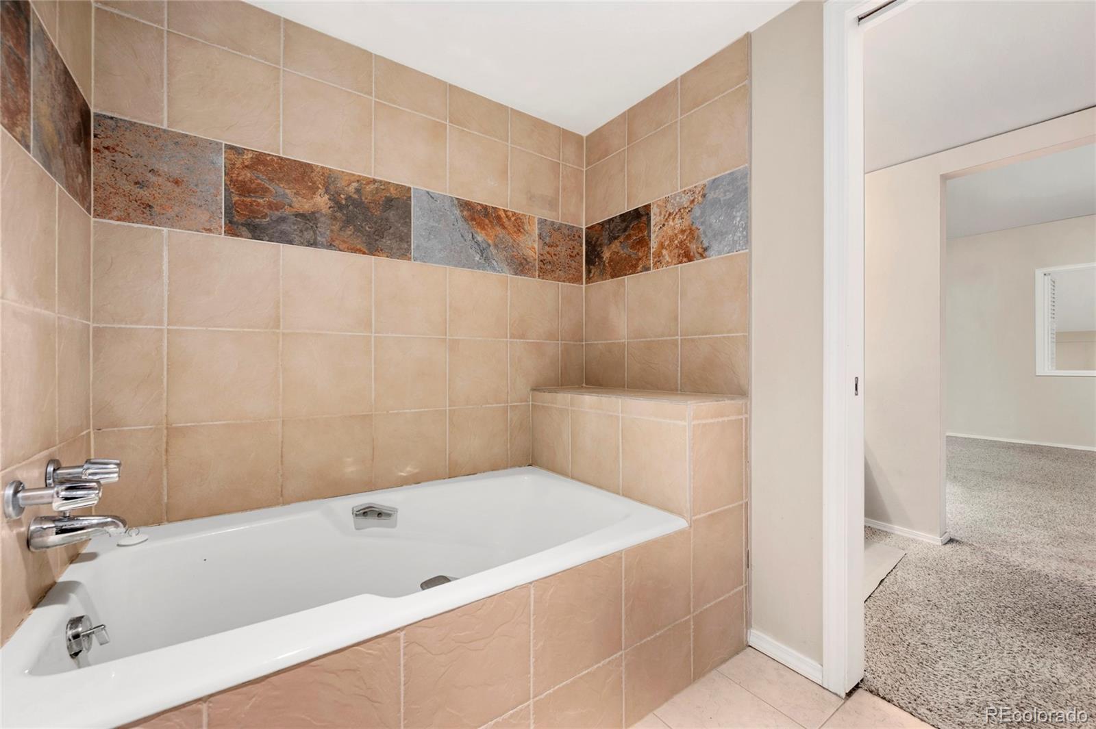 1512 Larimer Street, Unit 21 Denver, CO 80202 - Photo 9 of 18 a bathroom with a bathtub and shower