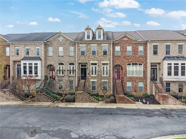 a front view of a residential apartment building with a yard