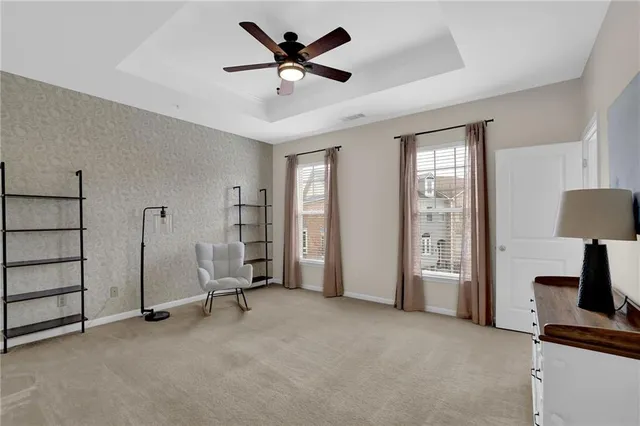 a view of room with furniture and a ceiling fan