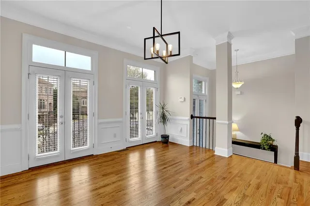 a view of a room with wooden floor and windows