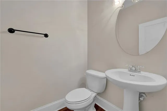 a white toilet sitting next to a bathroom sink
