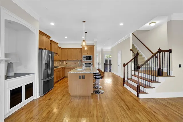 a kitchen with stainless steel appliances a refrigerator and a stove top oven