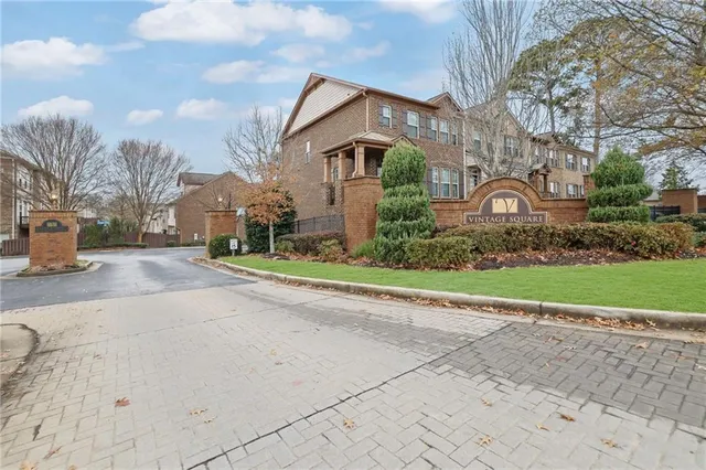 a front view of a house with a garden and pathway