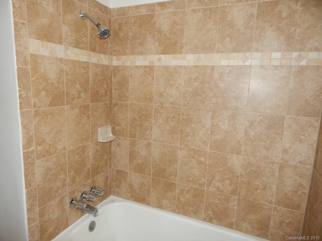 623 Fortune Street Charlotte, NC 28205 - Photo 11 of 15 a bathroom with a bathtub and a shower