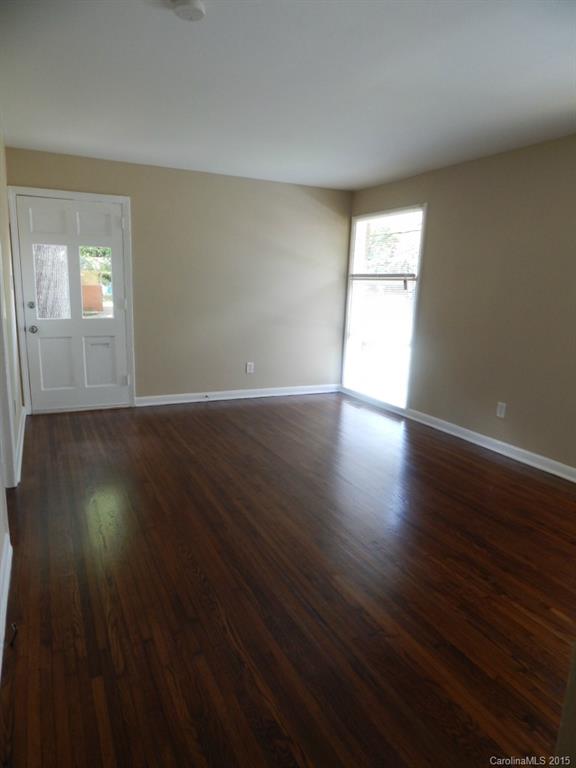 623 Fortune Street Charlotte, NC 28205 - Photo 4 of 15 a view of an empty room with wooden floor and a window