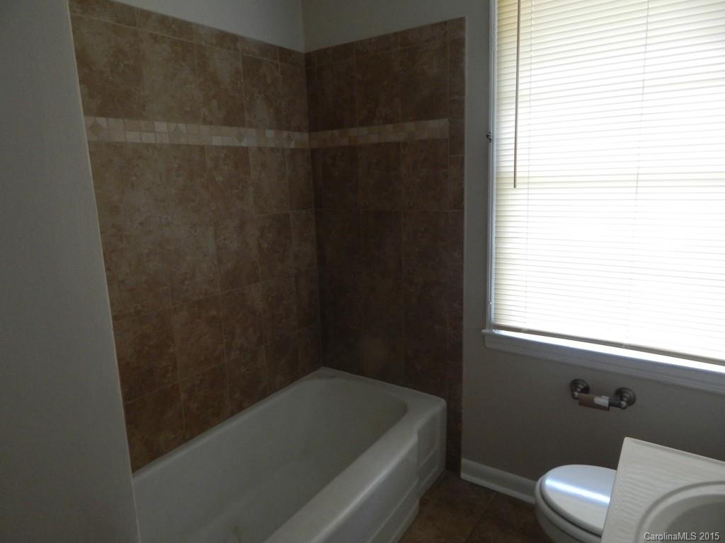 623 Fortune Street Charlotte, NC 28205 - Photo 10 of 15 a bathroom with a bathtub and window