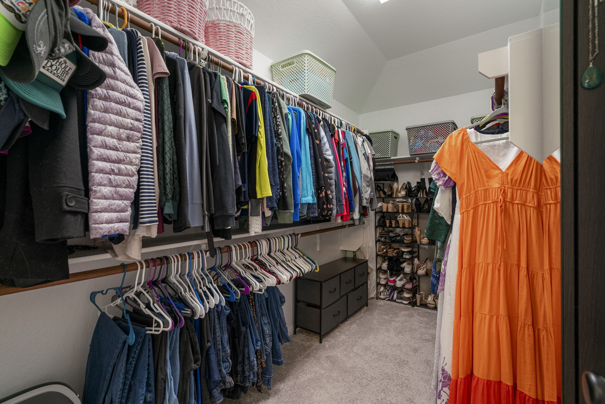 19412 Forman Drive Pflugerville, TX 78660 - Photo 21 of 34 The spacious walk-in closet offers generous storage with multiple hanging areas and shelving, making it easy to keep clothing and accessories organized.