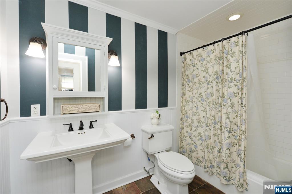 570 Shelton Road Ridgewood, NJ 07450 - Photo 16 of 26 a bathroom with a sink toilet and mirror
