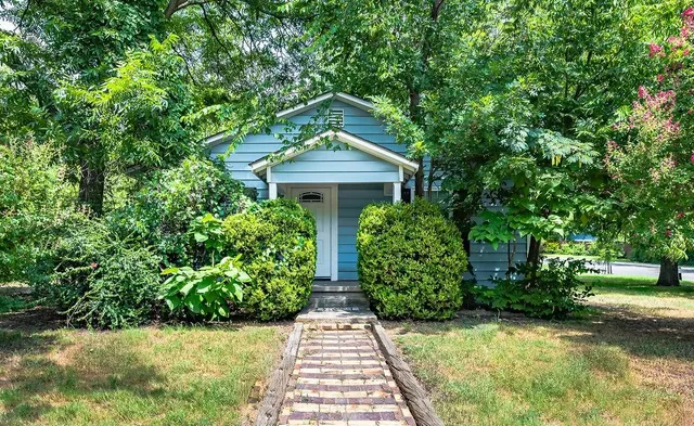 a front view of a house with garden