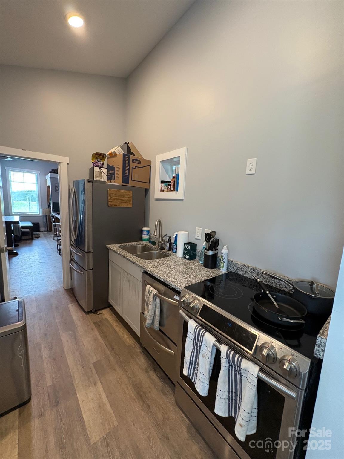 Vac Eddins-Poplin Road Norwood, NC 28128 - Photo 16 of 17 a kitchen with granite countertop a stove and a refrigerator
