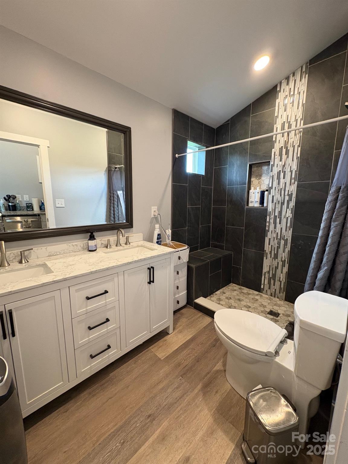 Vac Eddins-Poplin Road Norwood, NC 28128 - Photo 17 of 17 a bathroom with a double vanity sink toilet mirror and shower