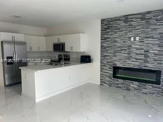 a kitchen with stainless steel appliances a stove a sink and a microwave
