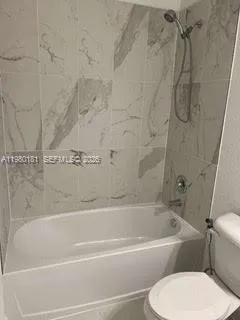 a bathroom with a toilet sink shower and mirror