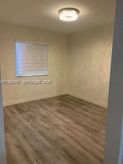 an empty room with wooden floor