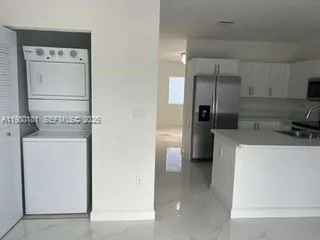 a kitchen with stainless steel appliances a refrigerator and cabinets