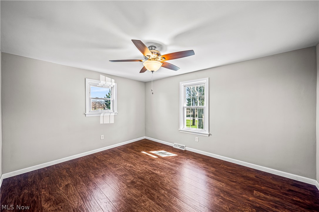 3395 Maple Road Jefferson, OH 44047 - Photo 21 of 36 Unfurnished room featuring dark wood-type flooring and ceiling fan