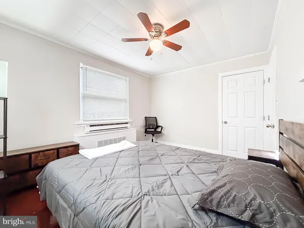 a bedroom with a bed and a ceiling fan