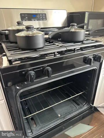 a stove top oven sitting inside of a kitchen