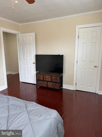 a bedroom with furniture and flat screen tv