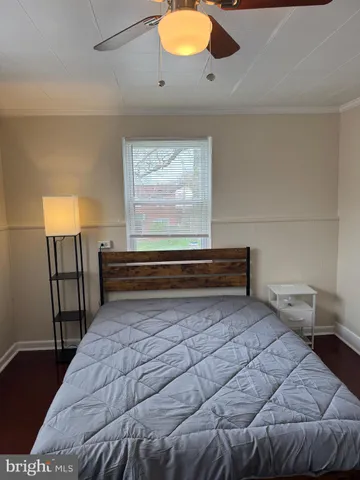 a bedroom with a bed and window