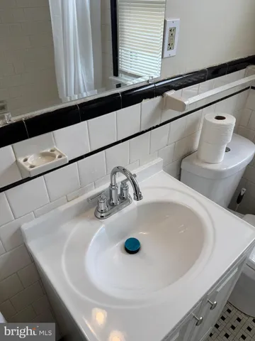 a kitchen with granite countertop a sink stove and cabinets
