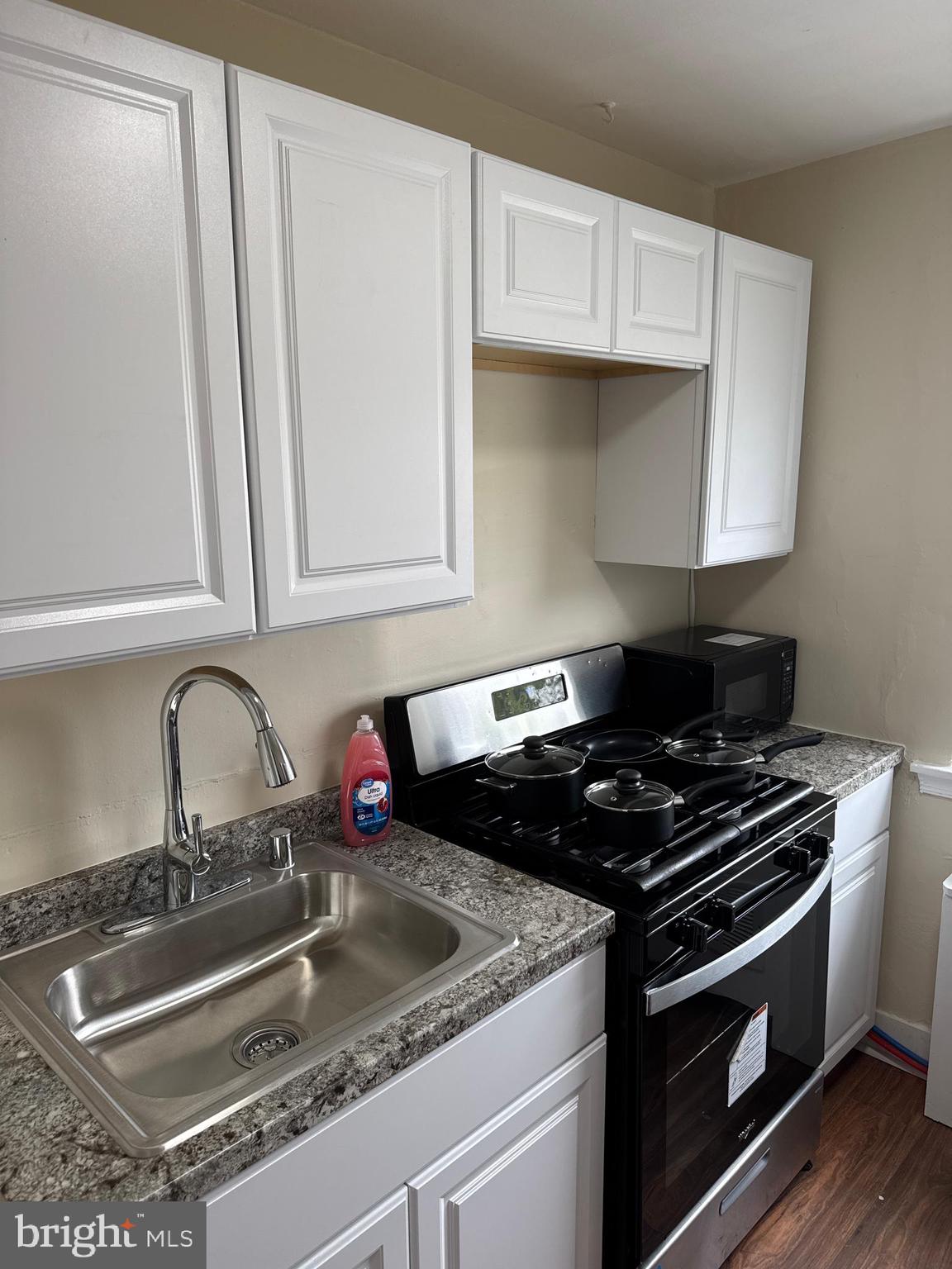 8529 Chestnut Oak Road, Unit 2 Parkville, MD 21234 - Photo 36 of 50 a kitchen with granite countertop a sink stove and cabinets