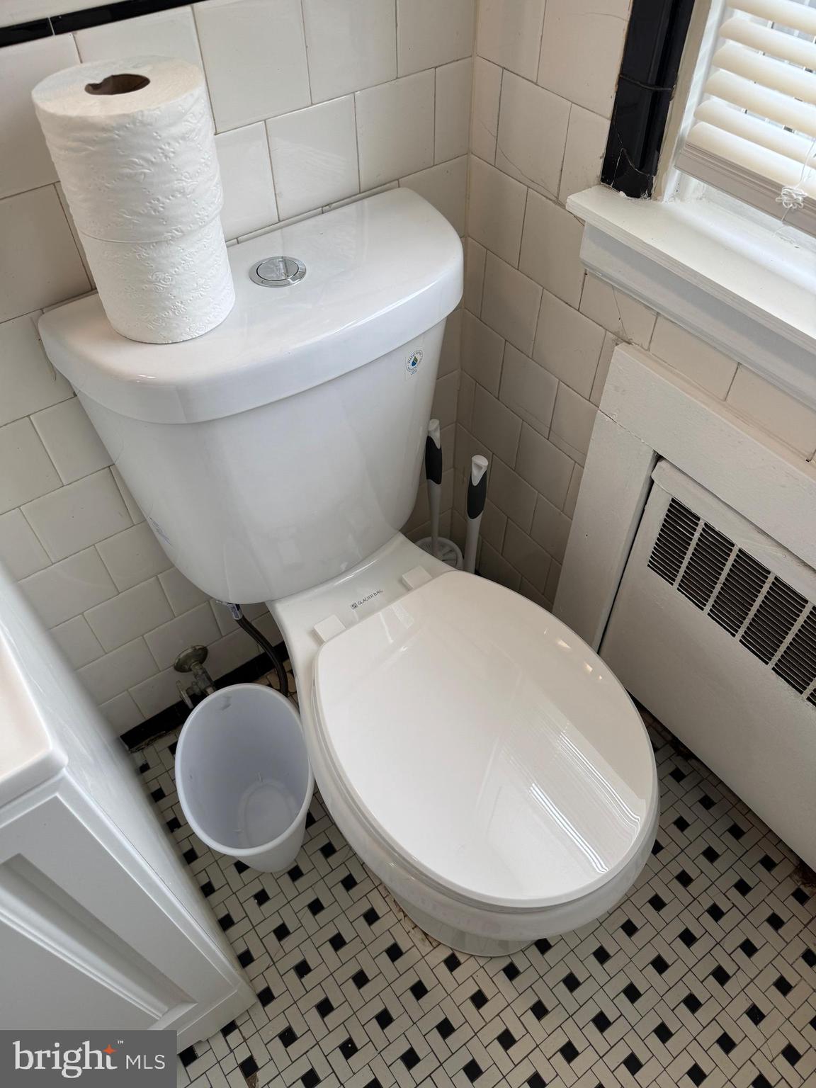 8529 Chestnut Oak Road, Unit 2 Parkville, MD 21234 - Photo 41 of 50 a bathroom with a toilet and a mirror