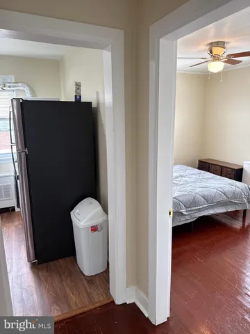 a bedroom with a bed and chandelier fan