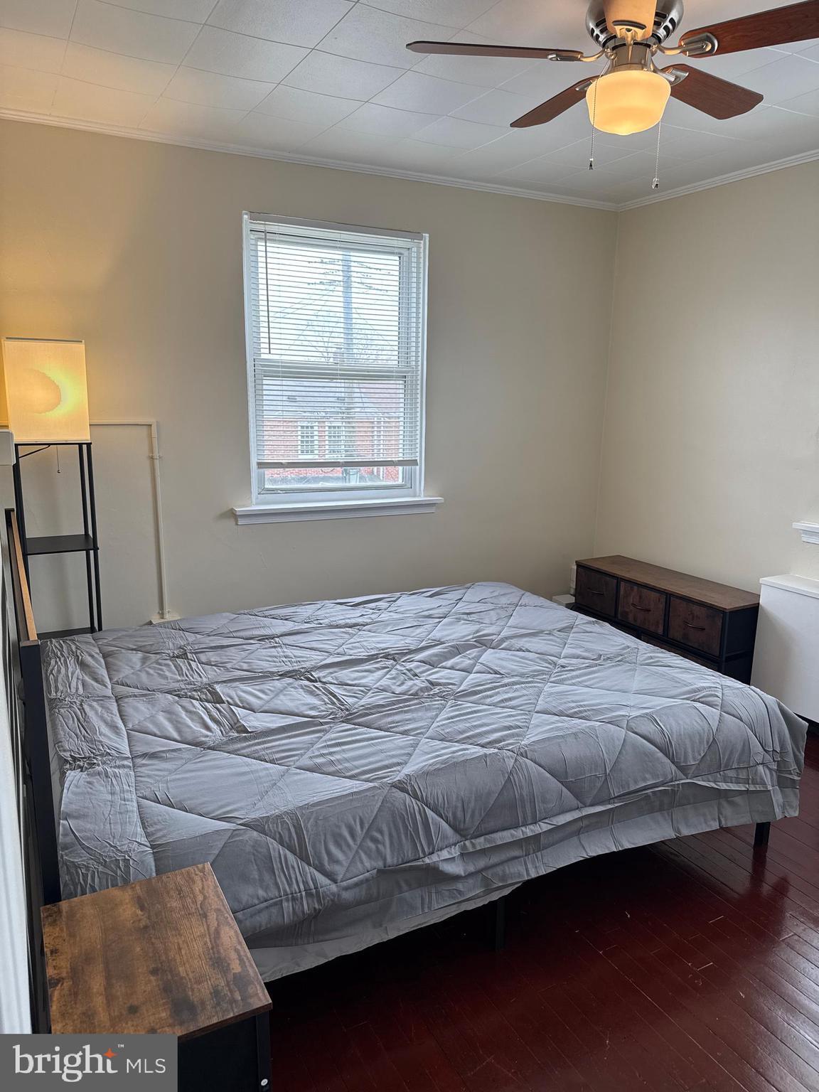 8529 Chestnut Oak Road, Unit 2 Parkville, MD 21234 - Photo 45 of 50 a bedroom with a bed and chandelier fan