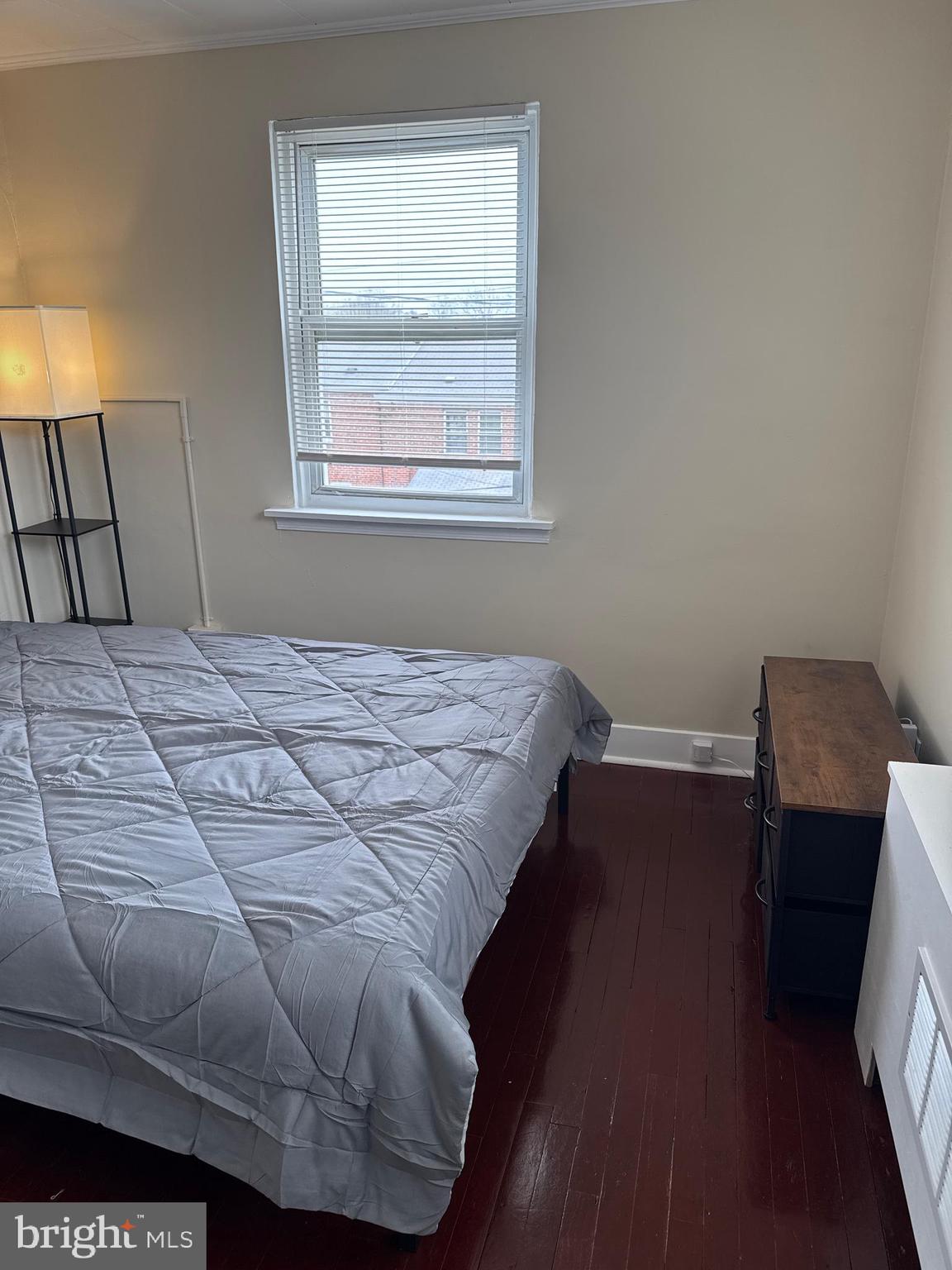 8529 Chestnut Oak Road, Unit 2 Parkville, MD 21234 - Photo 47 of 50 a bedroom with a bed and wooden floor