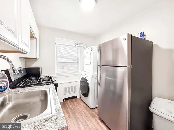 a kitchen with a refrigerator a washer and dryer