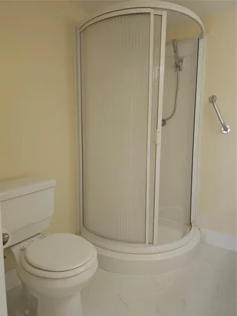 a bathroom with a toilet and shower