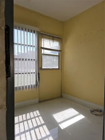 a view of an empty room with a window