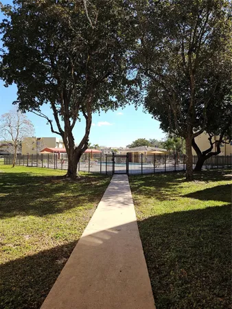 a view of swimming pool with trees in the background